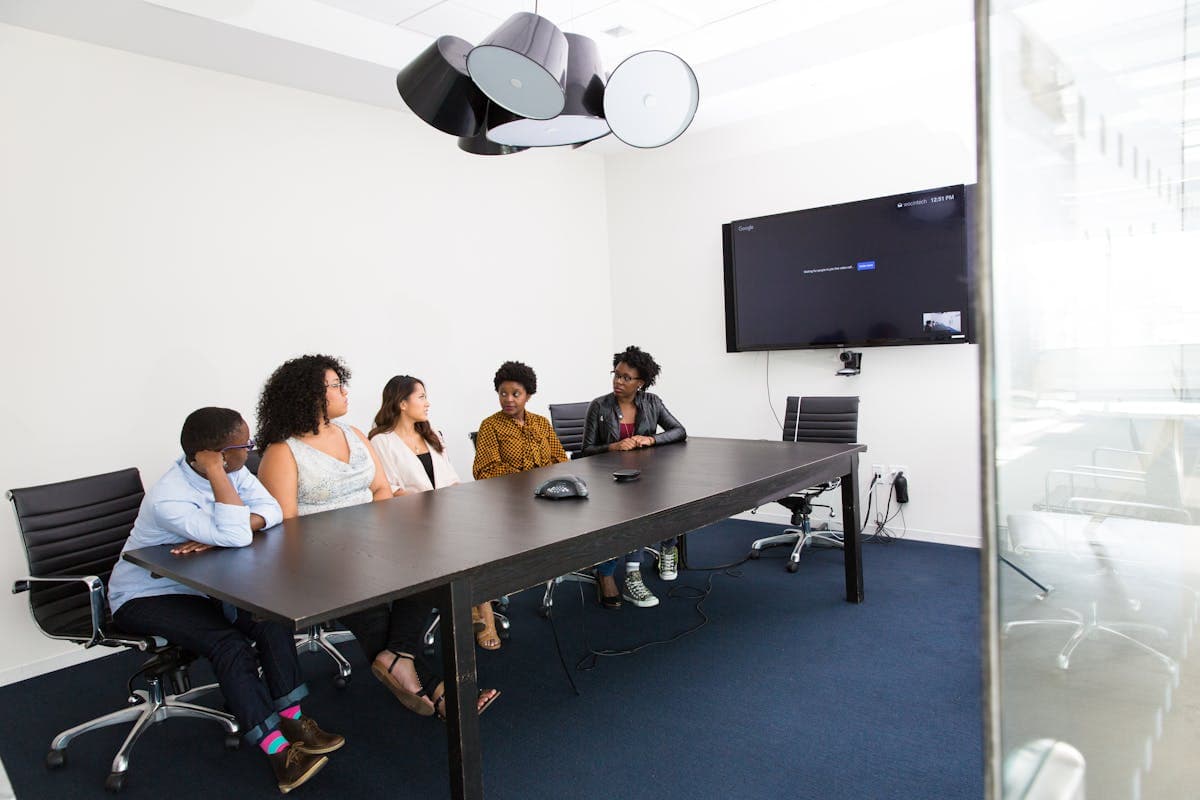 Team of professionals in meeting in modern office — symbolizing collaboration and change management in AI adoption