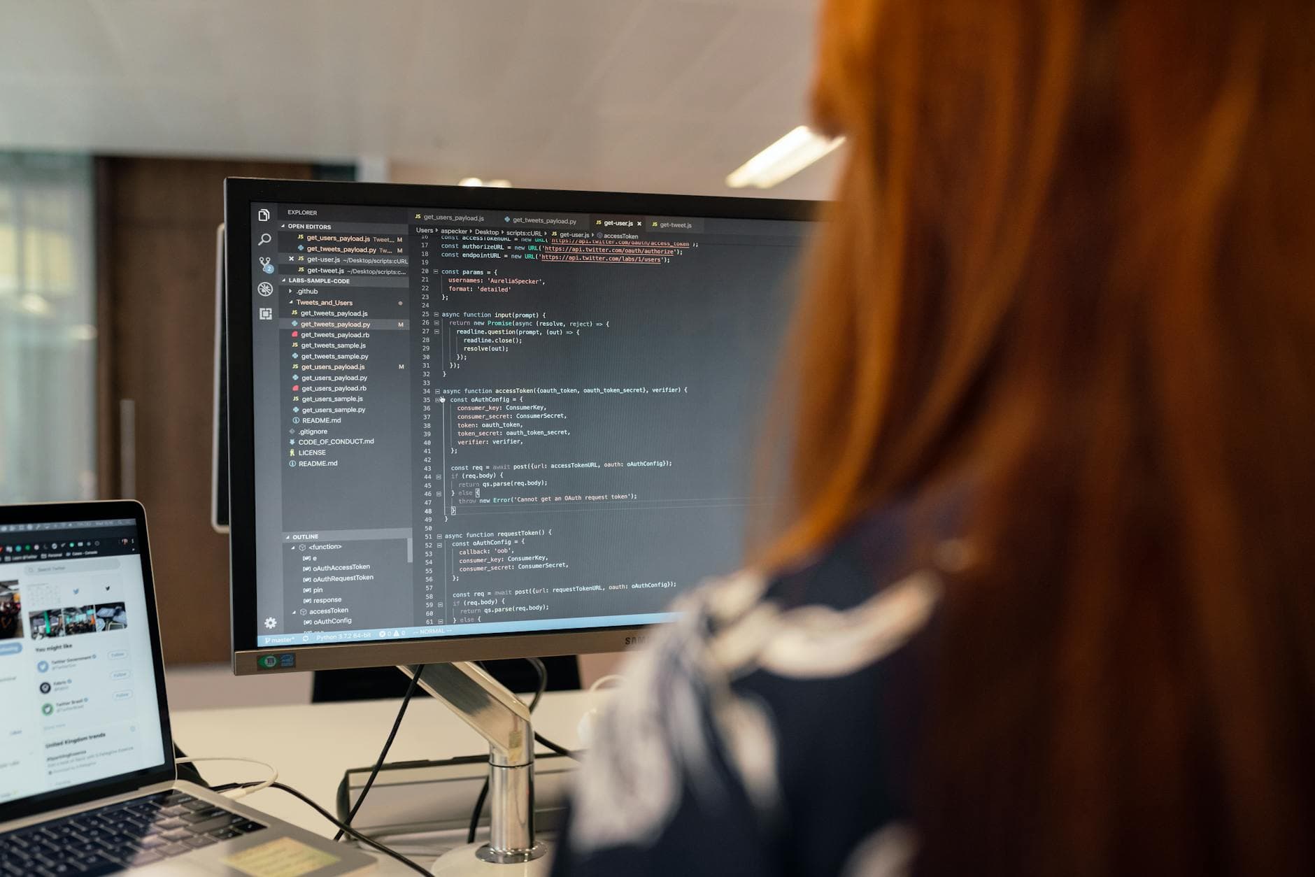 Developer in front of code on screen in an office setting — symbolizing operation and maintenance of AI automation